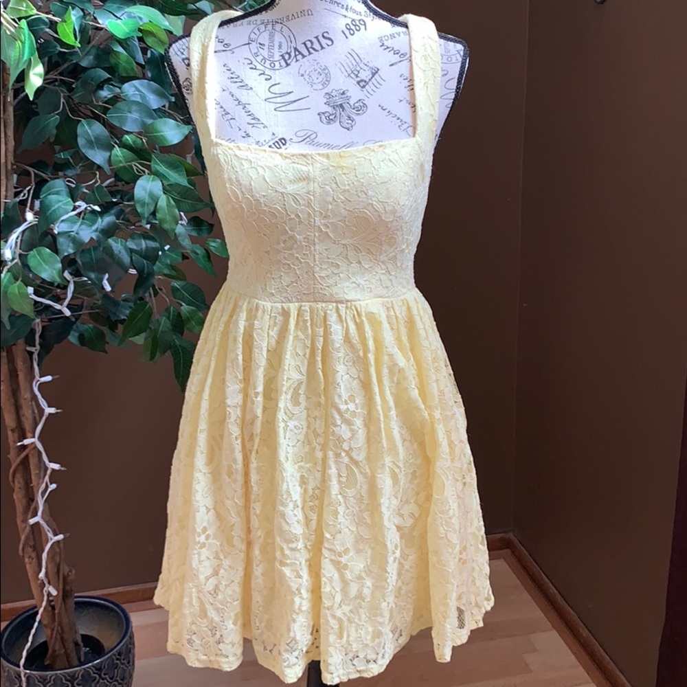 Yellow lace fit and flare dress with open back